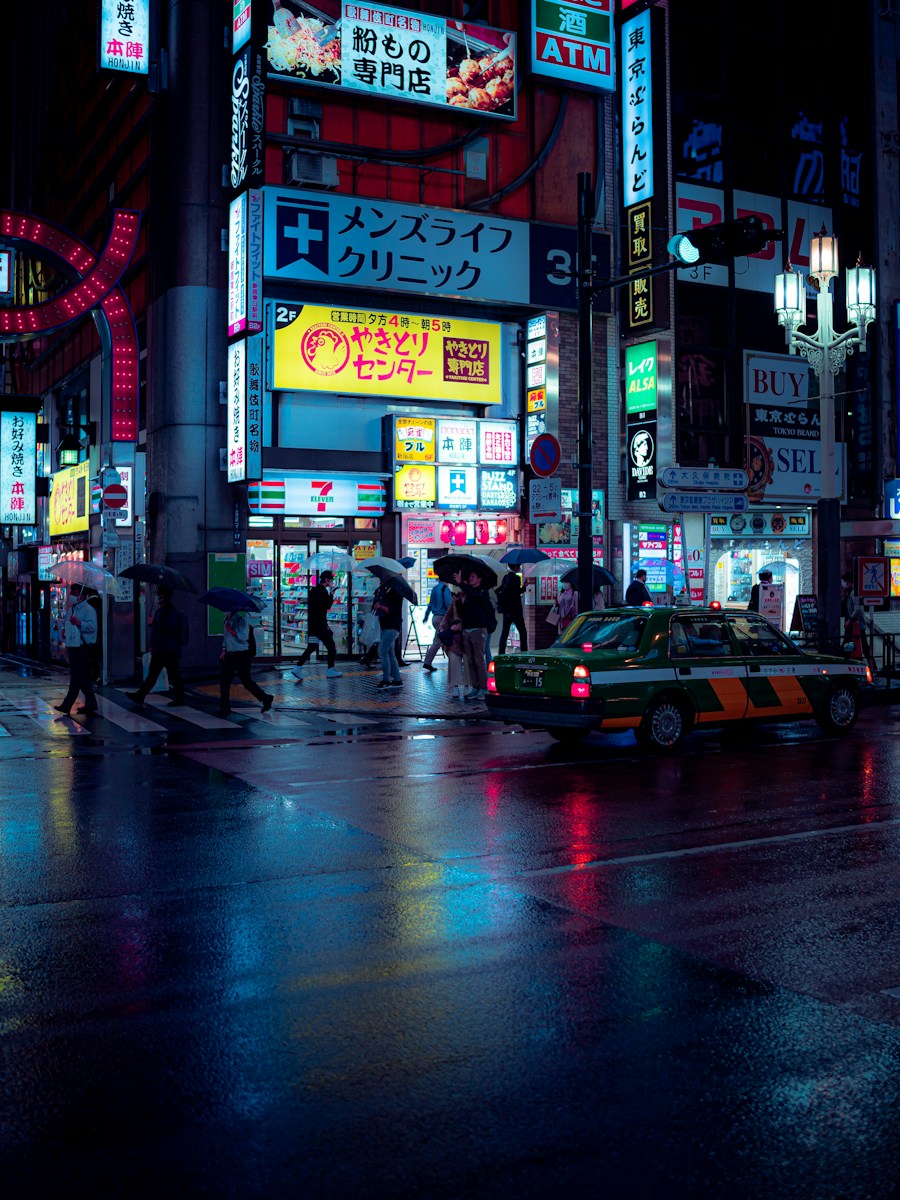 A rainy night street in Tokyo with neon signs