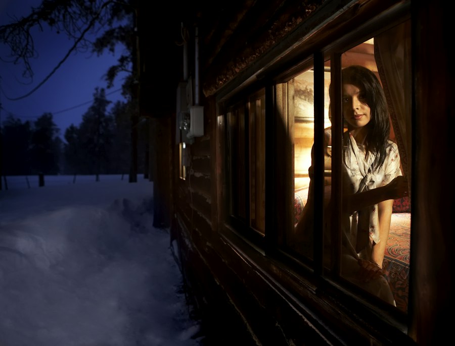 Warm lit window of a cabin at night