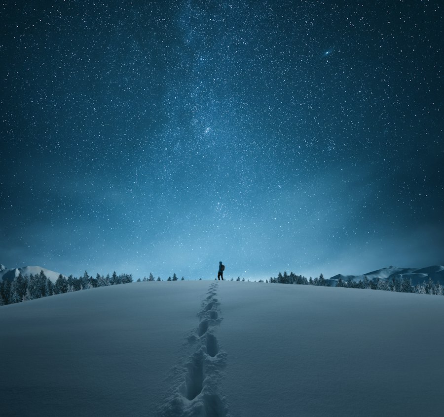 Walker in deep snow under a starry sky