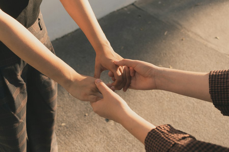 Three people holding hands in a circle